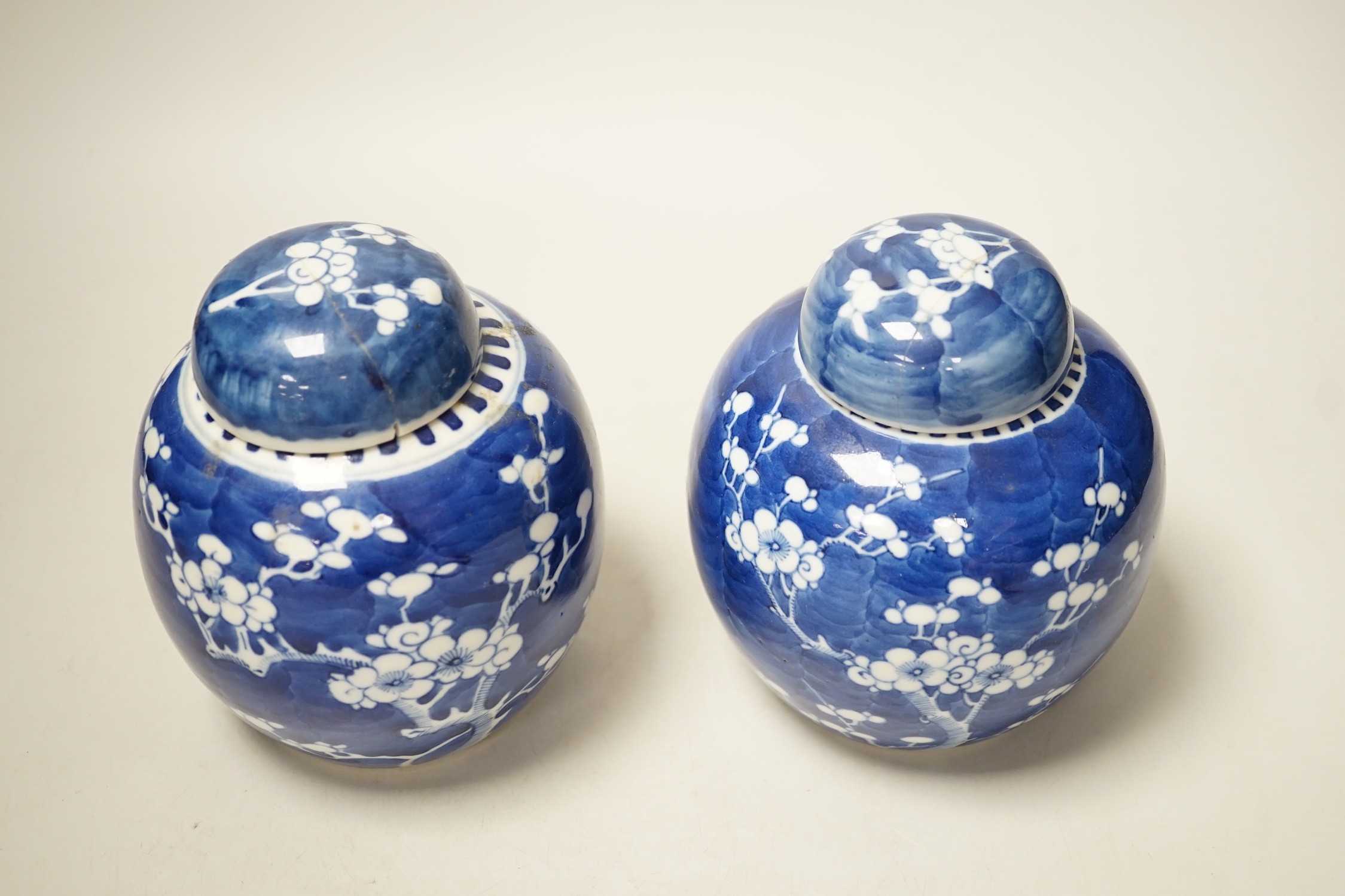 A pair of Chinese Blue and white prunus ginger jars. 15cm tall